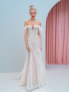 Style #2223, shimmering lace fit and flare wedding dress with detachable off the shoulder sleeves and tulle train, available in ivory, ivory-nude