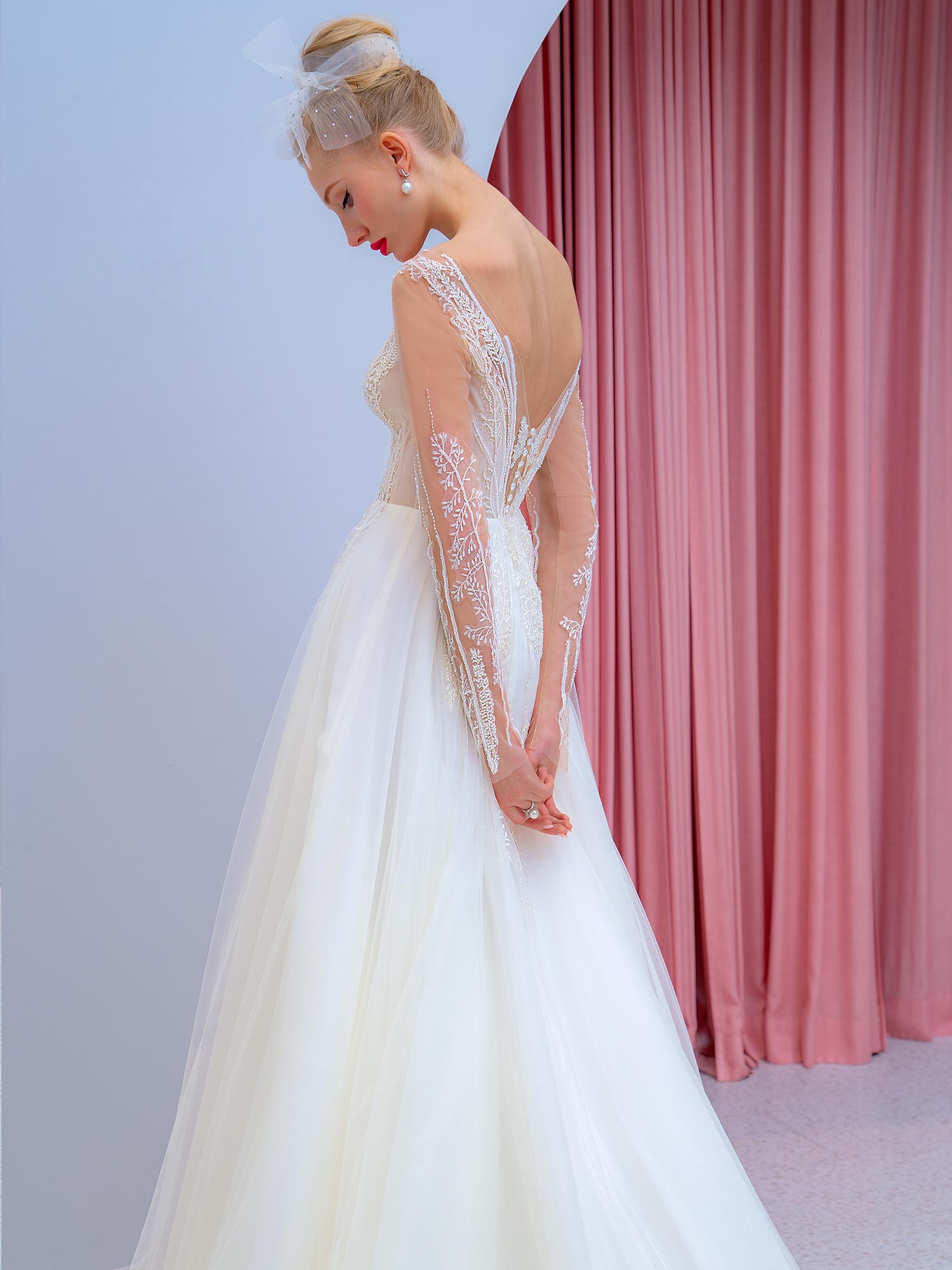 Style #2204L, long-sleeve A-line wedding dress with floral embroidery, available in ivory