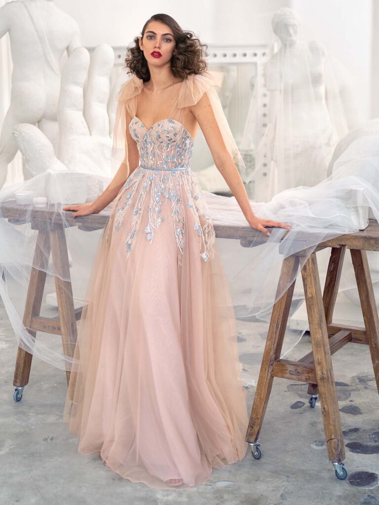 Style #647, bustier style A-line gown with floral embroidery and bow straps; available in nude -pink
