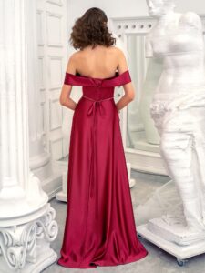 Style #649, satin sheath evening gown with off the shoulder sleeves and beaded belt; available in burgundy, ivory, green, red