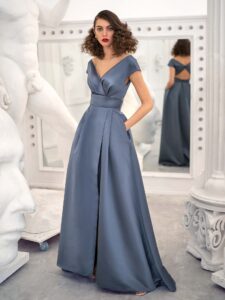 Sophisticated steel blue evening gown with open back and cap sleeves, perfect for elegant Toronto wedding guest dresses.