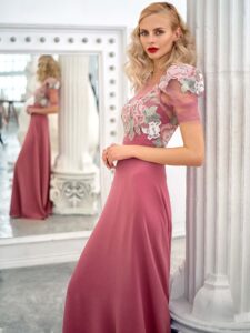 Style #668, short sleeve sheath evening gown with extended shoulders and embroidered top; available in lilac, pink