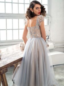 Style #669b, A-line cocktail dress with puffed sleeves and embroidered top; available in maxi length only; in nude-blue