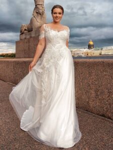 Style #2247L, Short sleeve plus size A-line wedding dress with lace décor; available in ivory
