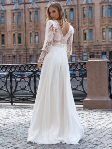 Long sleeve wedding dress with a flowy skirt; available in ivory-nude, ivory