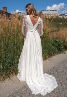 Style #14003, A-line wedding dress with long sleeves and skirt slit; available in ivory