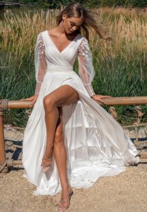 Style #14003, A-line wedding dress with long sleeves and skirt slit; available in ivory