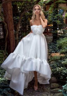 Style #14008, Strapless high-low wedding dress with bow decor and ruffles; available in ivory