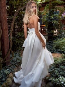 Strapless high-low wedding dress with bow decor and ruffles