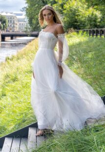 Style #14010, Ball gown wedding dress with asymmetric neckline and long sleeves; available in ivory