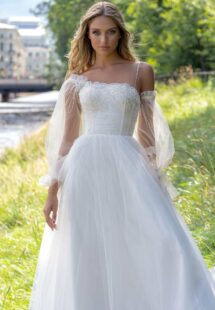 Style #14010, Ball gown wedding dress with asymmetric neckline and long sleeves; available in ivory