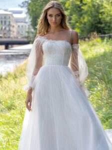 Ball gown wedding dress with asymmetric neckline and long sleeves