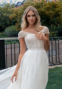Style #14012, Ballgown wedding dress with an off-the-shoulder neckline and pearl decor; available in ivory