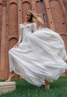 Style #14017, Long-sleeve sheath wedding dress with bustier style corset; available in ivory