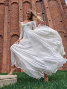 Long-sleeve sheath wedding dress with bustier style corset