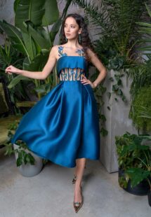 Style #729a, A-line formal dress with an illusion neckline and floral embroidery; available in midi or maxi length; in sea green, lilac, grey-blue, ivory