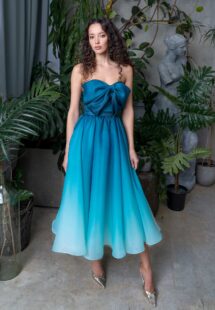 Style #731a, A-line tea-length organza ombre dress with a bow accent; available in midi or maxi length; in emerald, lavender