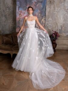 Floral ballgown wedding dress with a straight neckline and spaghetti straps