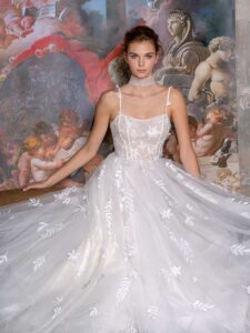 Floral ballgown wedding dress with a straight neckline and spaghetti straps