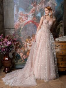 Pale blush A-line wedding dress with bustier style corset and 3D flower embroidery; available in ivory-powder, ivory