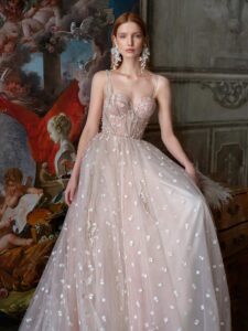 Pale blush A-line wedding dress with bustier style corset and 3D flower embroidery; available in ivory-powder, ivory