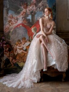 Pale blush A-line wedding dress with bustier style corset and 3D flower embroidery; available in ivory-powder, ivory