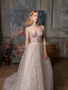 Pale blush A-line wedding dress with bustier style corset and 3D flower embroidery; available in ivory-powder, ivory