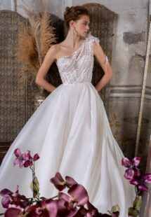 Style #2305L, one-shoulder ballgown wedding dress with lace bodice and organza slit skirt; available in ivory