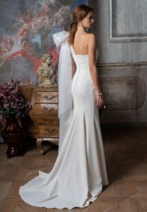 Style #2307L, one-shoulder fitted wedding dress with beading and oversized bow strap; available in ivory