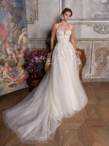 A-line wedding dress with thick straps, plunging bustier-style bodice and floral applique