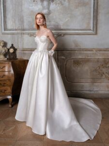Strapless Mikado ballgown with a bustier-style bodice, lace embroidery and buttons down the skirt