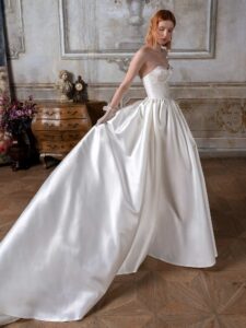 Strapless Mikado ballgown with a bustier-style bodice, lace embroidery and buttons down the skirt