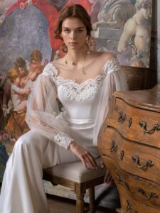 Long sleeve fit and flare wedding dress with an illusion off-the-shoulder lace neckline