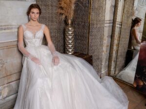 Ballgown wedding dress with an illusion V-neckline and beaded lace embroidery; available in cream