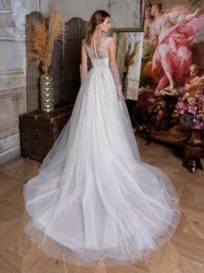 Ballgown wedding dress with an illusion V-neckline and beaded lace embroidery; available in cream