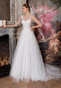 Style #2315L, sequinned lace ballgown with an illusion bustier-style bodice and puff long sleeves; available in ivory