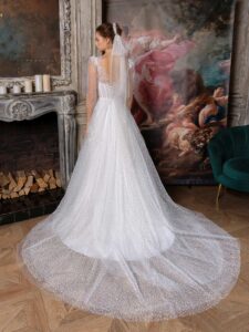 Sequinned lace ballgown with an illusion bustier-style bodice and puff long sleeves