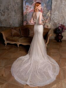 Sparkly fit and flare wedding dress with floral embroidery and shoulder beading; available in cream