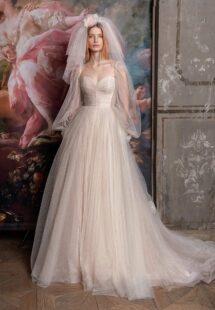 Style #2318L, shimmering tulle peach ballgown with draped sweetheart bodice and long bishop sleeves; available in peach