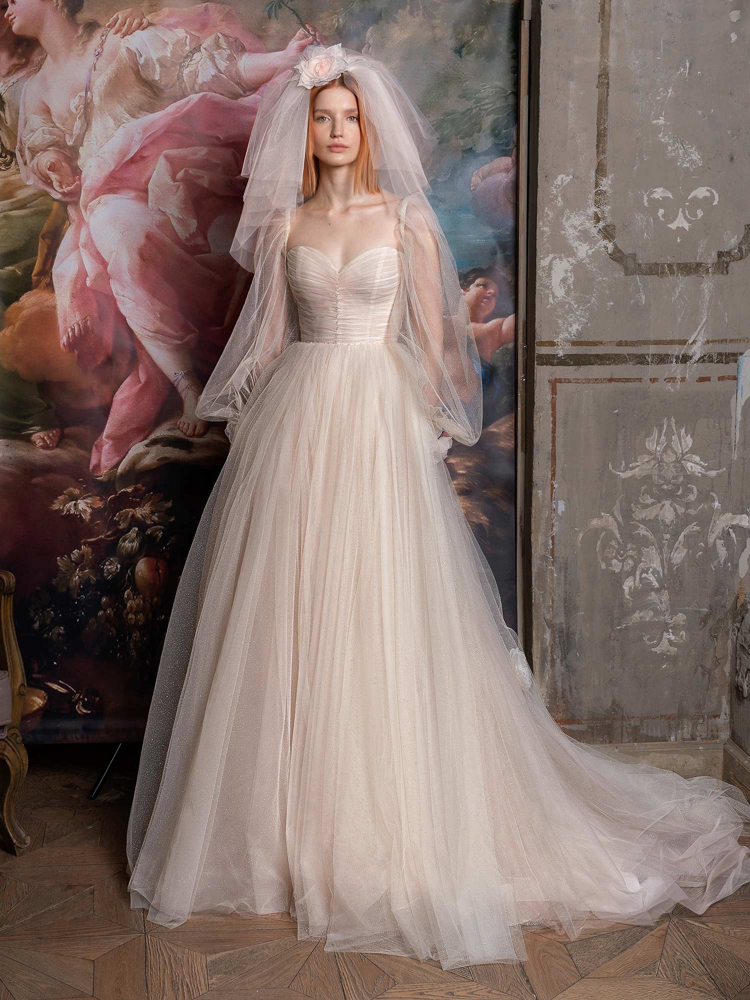 Style #2318L, shimmering tulle peach ballgown with draped sweetheart bodice and long bishop sleeves; available in peach