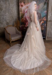 Style #2318L, shimmering tulle peach ballgown with draped sweetheart bodice and long bishop sleeves; available in peach