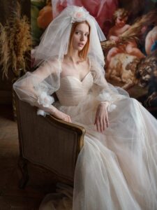 Shimmering tulle peach ballgown with draped sweetheart bodice and long bishop sleeves