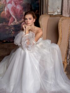 Strapless ballgown wedding dress with plunging V-neckline, floral applique and detachable bishop sleeves
