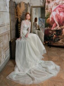 High-neck A-line wedding dress with long sleeves and floral embroidery; available in mint-powder, ivory