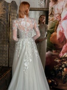 High-neck A-line wedding dress with long sleeves and floral embroidery; available in mint-powder, ivory
