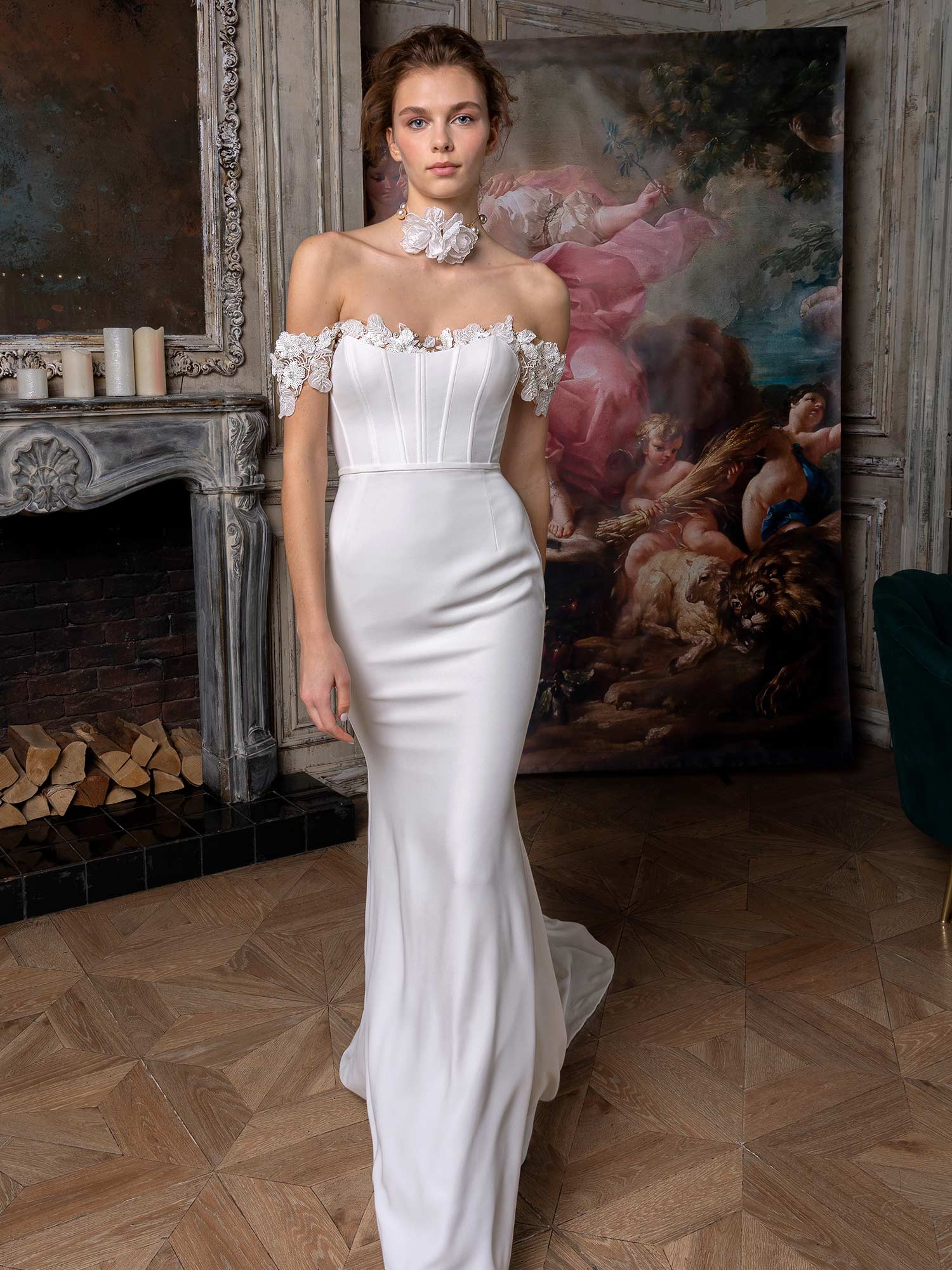 Style #2322L, simple fit and flare wedding gown with an off-the-shoulder sequinned lace decor; available in ivory