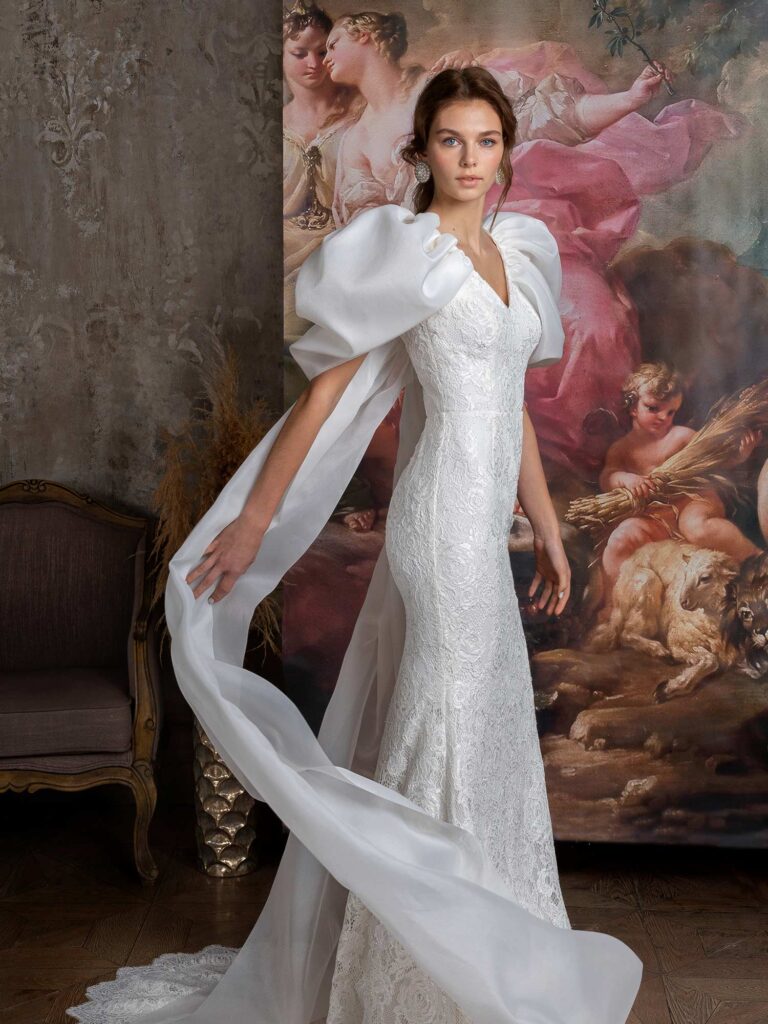 Style #2323L, voluminous sleeve fit and flare wedding dress with cape straps; available in ivory