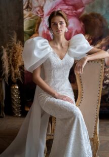 Style #2323L, voluminous sleeve fit and flare wedding dress with cape straps; available in ivory