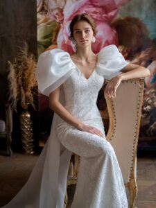 Voluminous sleeve fit and flare wedding dress with cape straps
