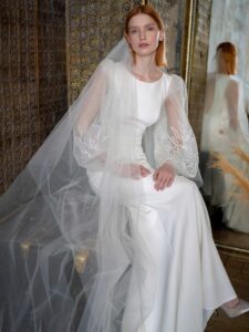Fit and flare wedding dress with long balloon sleeves and open back